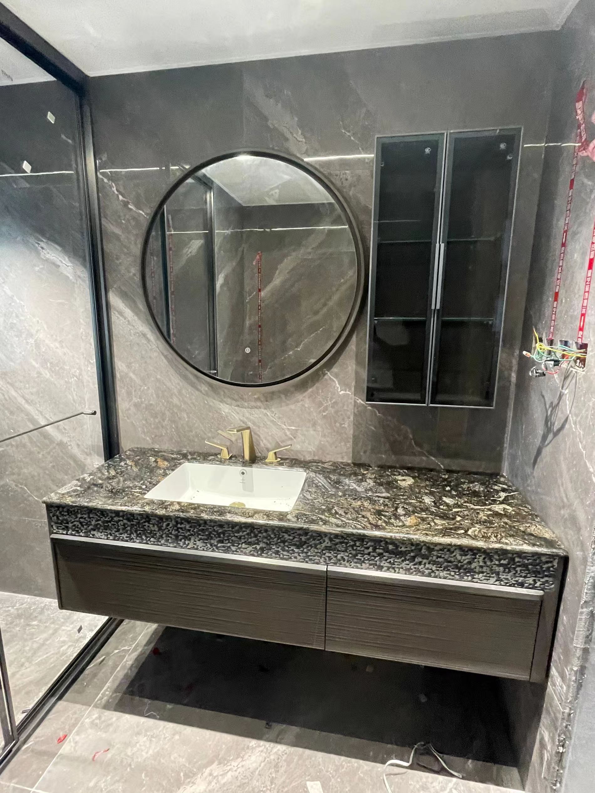 Shanhe Chenyuan Estate — solid stone vanity, circular LED mirror, dark stone wall