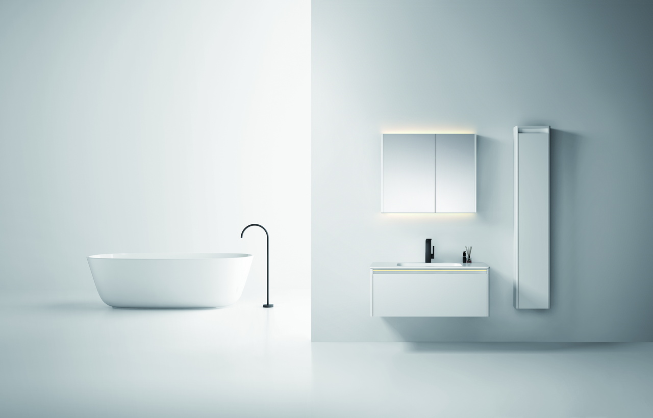 Person cleaning the open floor below a floating bathroom vanity with a mop in a bright bathroom