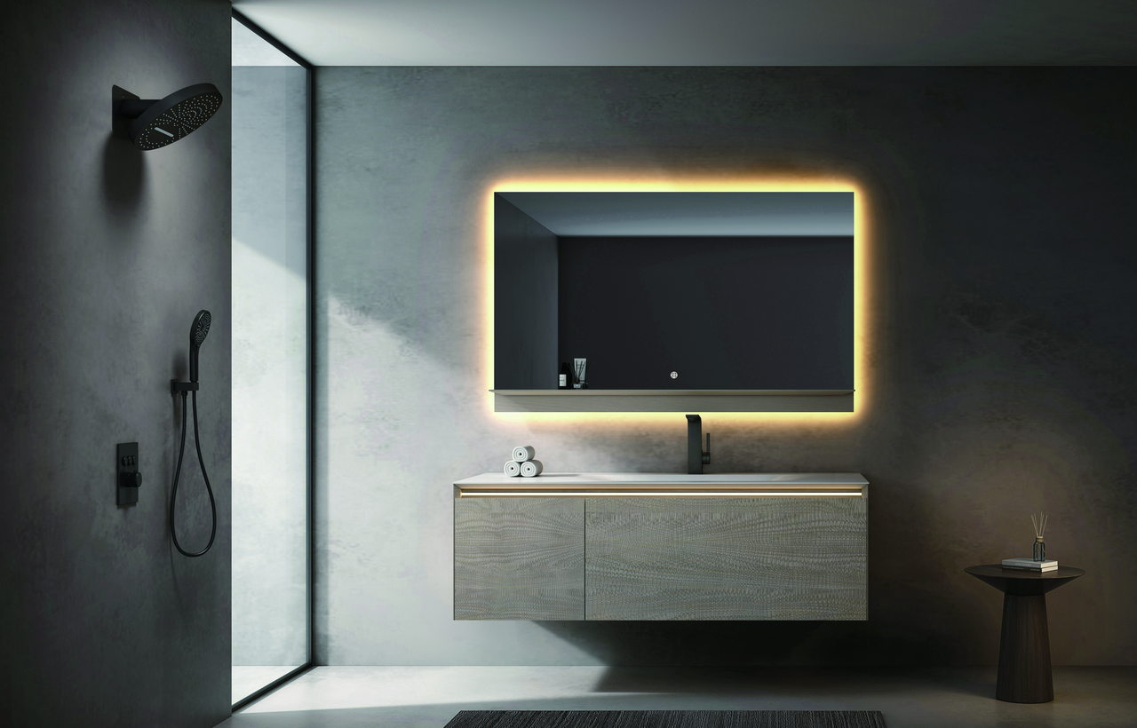 Person cleaning the visible floor beneath a floating bathroom vanity and wiping the cabinet surface with a soft cloth