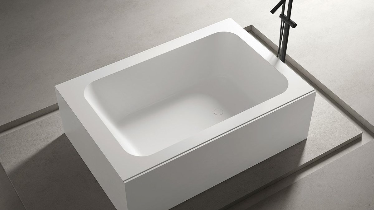 A built-in solid surface bathtub in an apartment bathroom