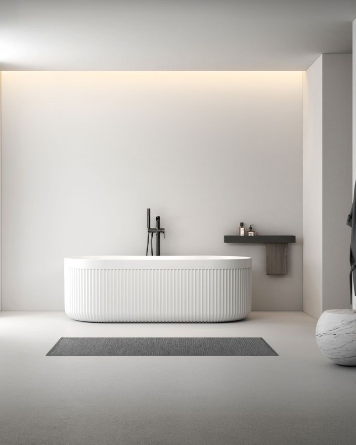A freestanding solid surface bathtub displayed in a showroom