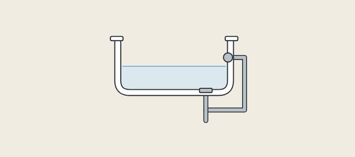 Illustration of a bathtub in section with an overflow on the end wall piped to the drain under the floor