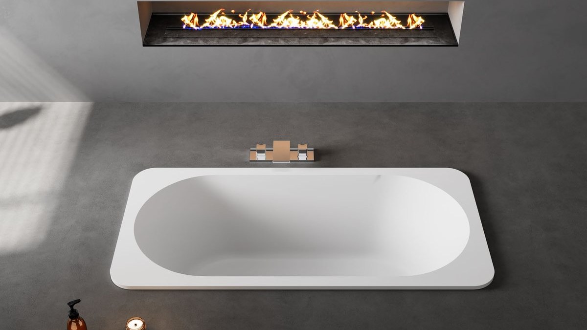A rectangular built-in solid surface bathtub set into a deck