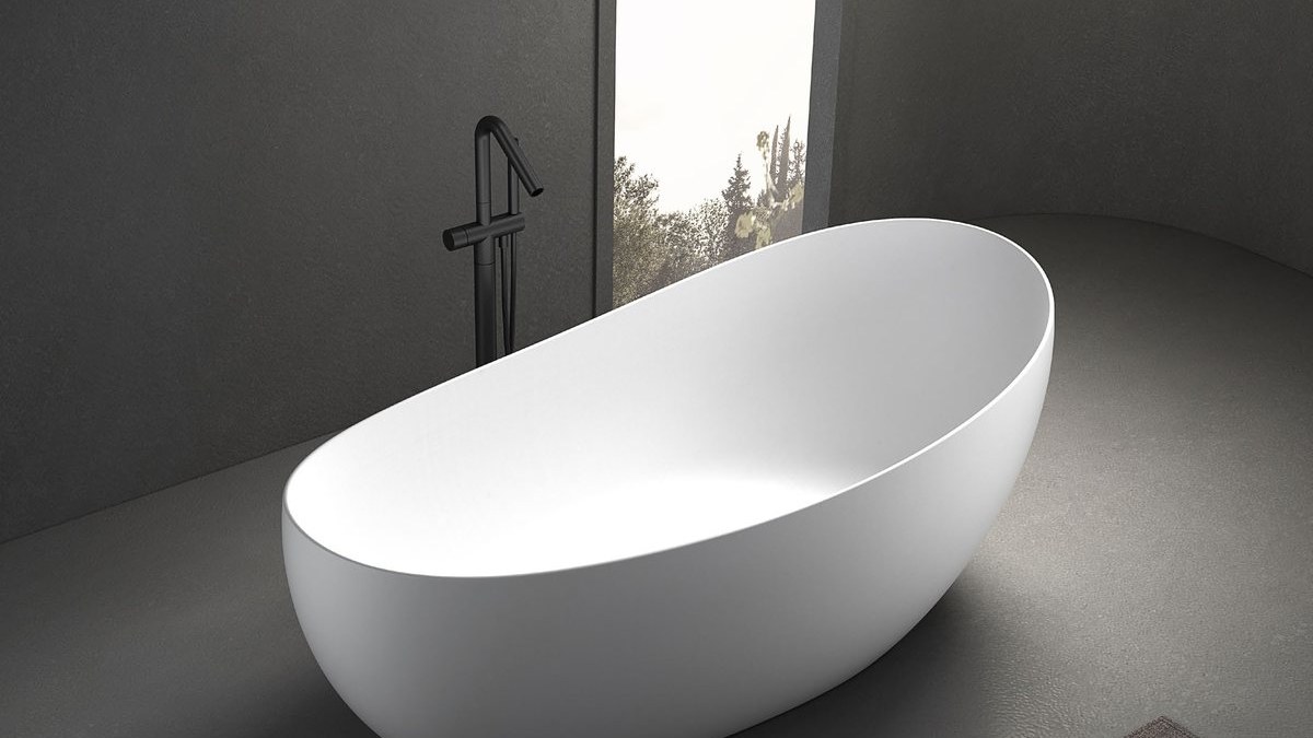 An oval freestanding solid surface bathtub