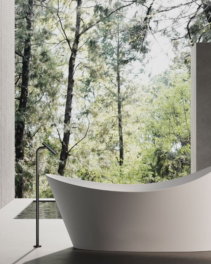 A freestanding solid surface bathtub in a residential bathroom