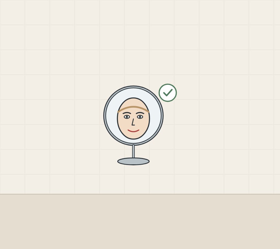 Illustration of a round mirror on a stand showing a whole face, with a tick