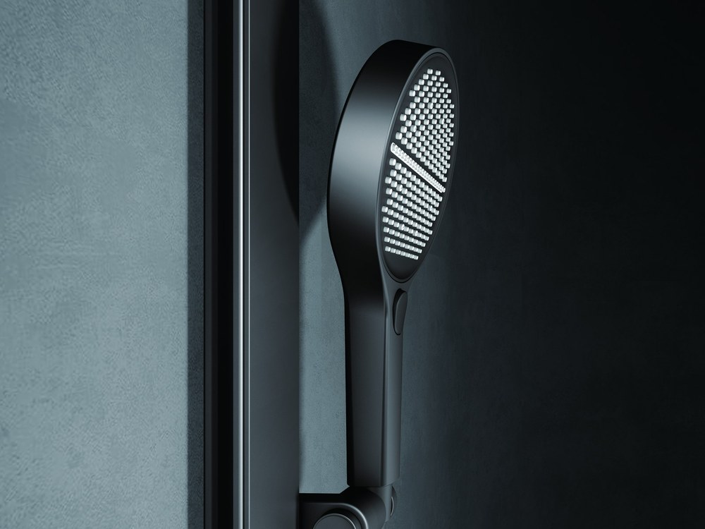 A black hand shower with a textured spray face