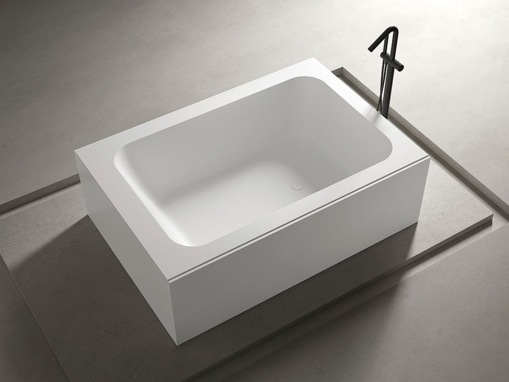 A built-in solid surface bathtub in an apartment bathroom