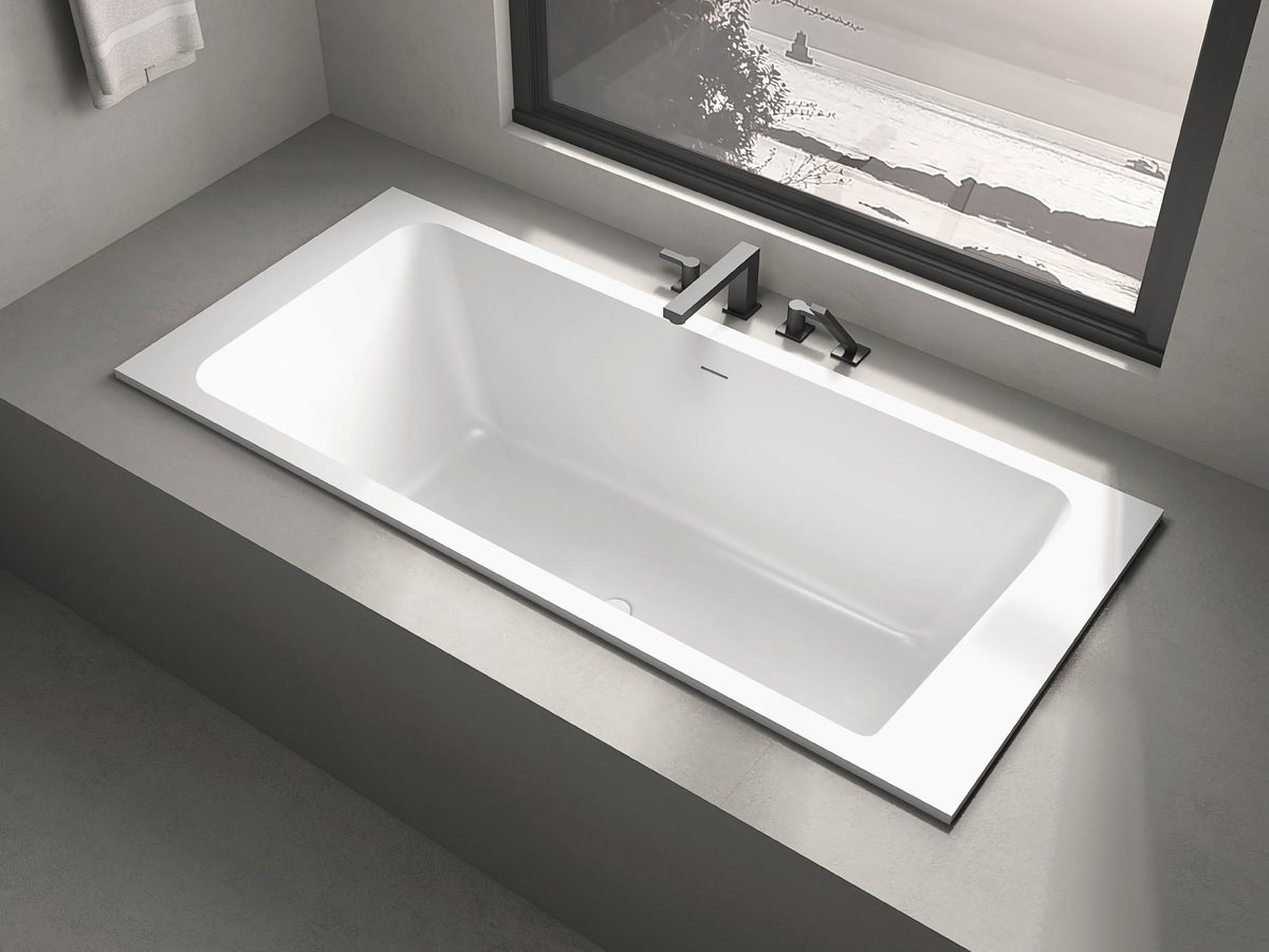 A built-in solid surface bathtub in a hotel suite bathroom