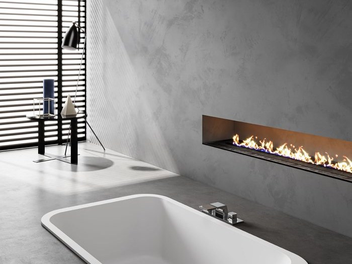 A rectangular solid surface bathtub set into a deck
