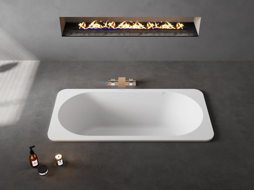 A rectangular built-in solid surface bathtub set into a deck