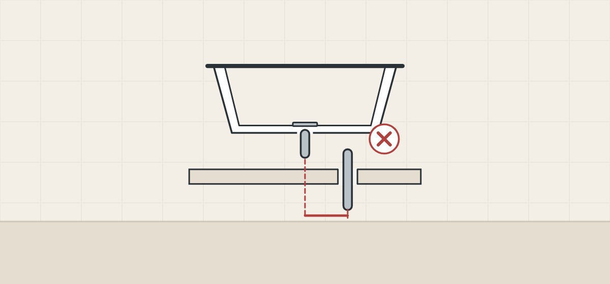 Illustration of a bathtub whose center drain sits to one side of the pipe standing through the floor