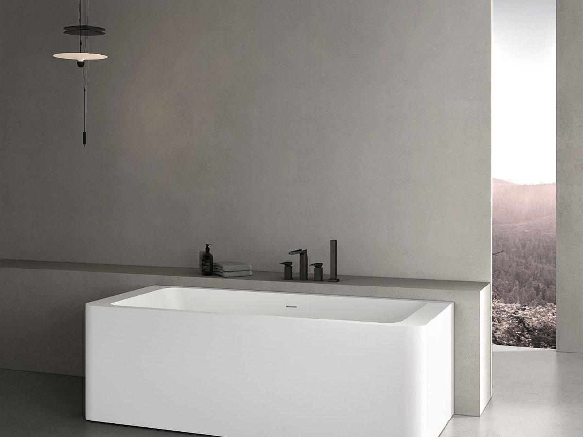Built-in bathtub set into a surround, representing a standard alcove size