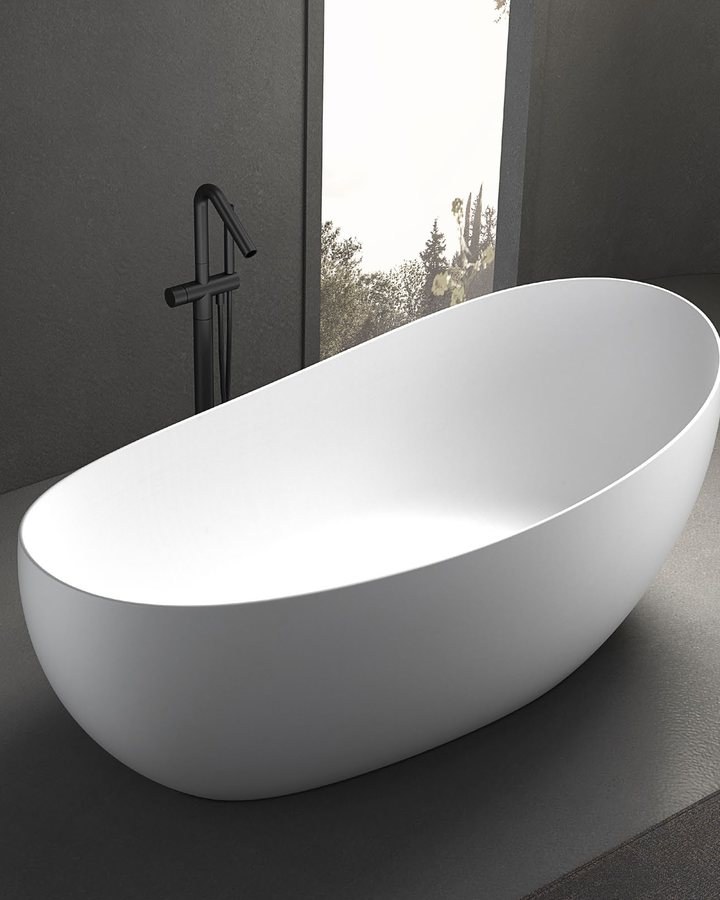 An oval freestanding solid surface bathtub