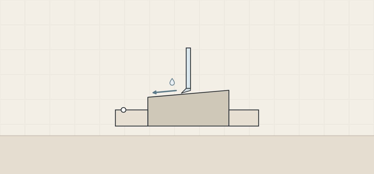 Illustration of a curb sloping toward the shower with a glass door and sweep above it