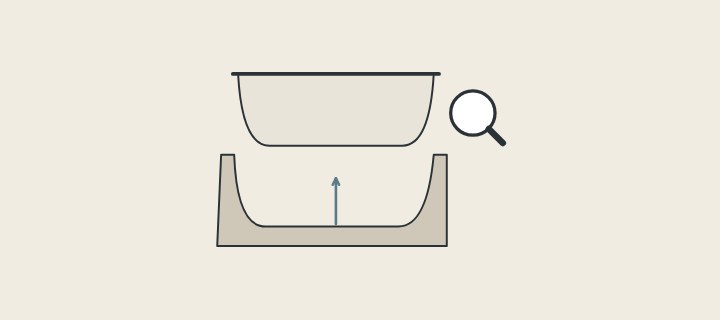 Illustration of a cast tub lifted above its open mold with a magnifier beside it