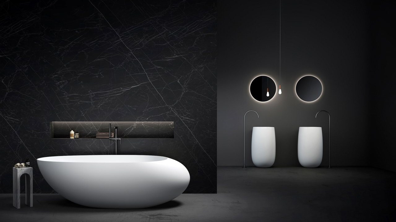 A white freestanding tub in a dark bathroom with two round mirrors