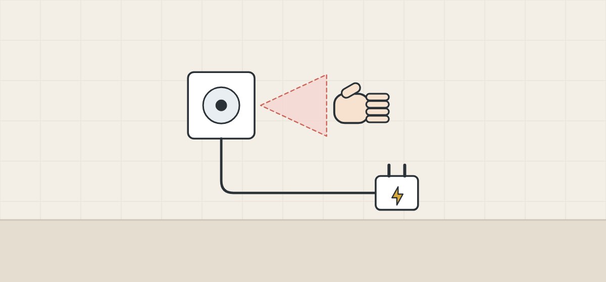 Illustration of a round sensor button with a sensing zone and a hand, connected by a lead to a plug-in power supply
