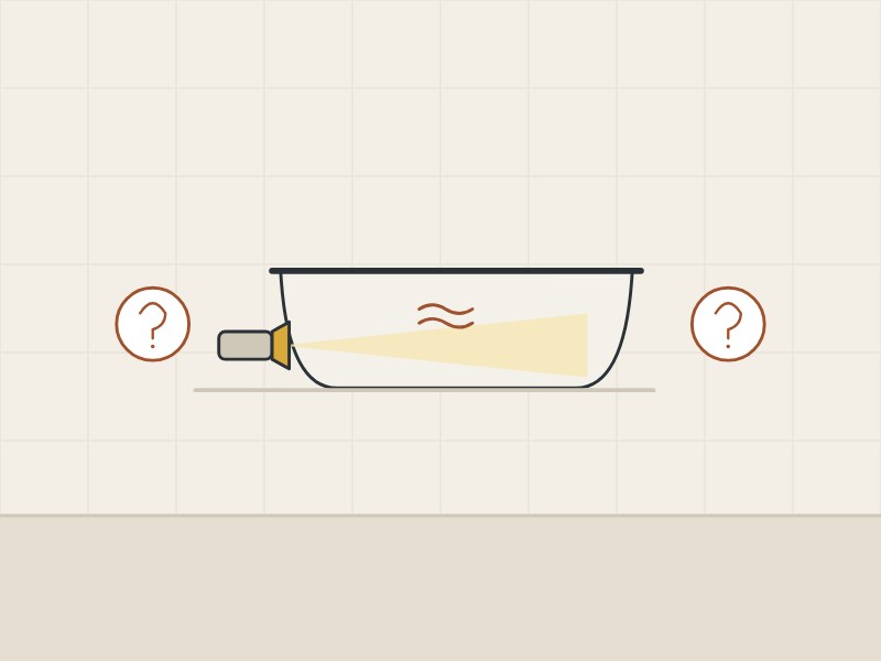 Illustration of a bathtub lit by a low lamp between two question marks