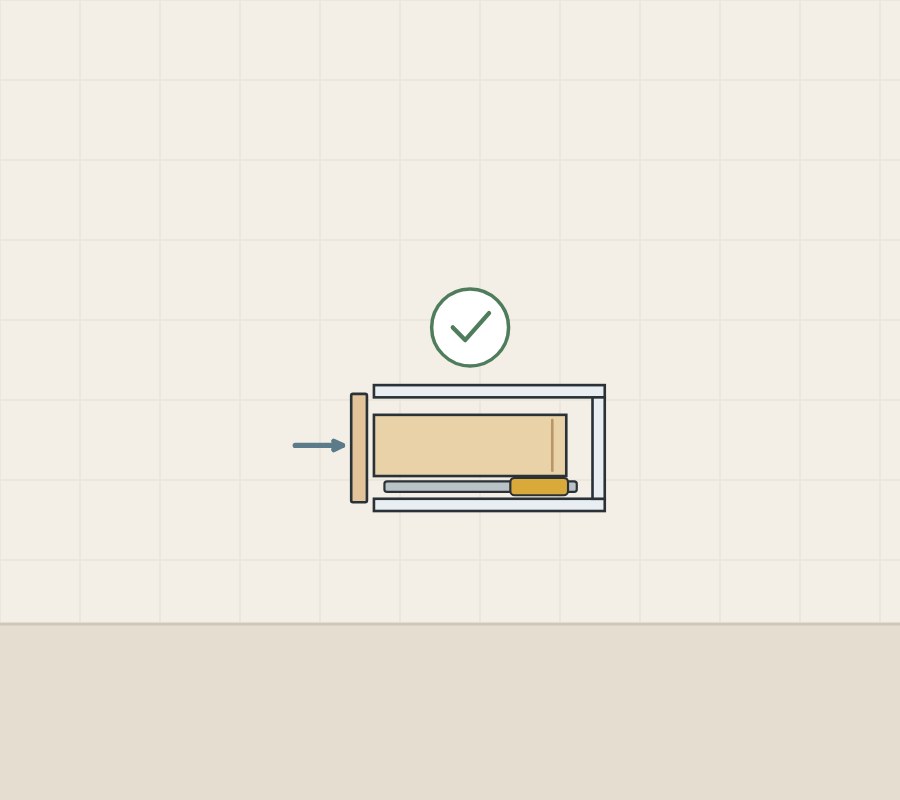 Illustration of a closed drawer in side section with its unit, an arrow pressing the front and a check mark