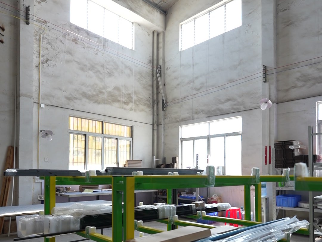 Shower enclosure assembly racks lined up in the production hall