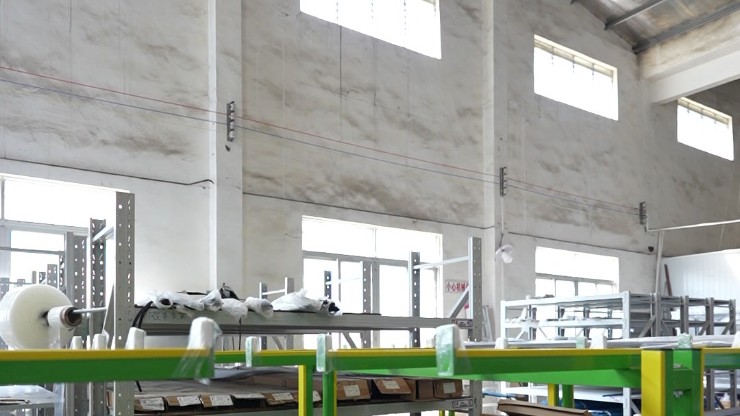 Aluminium profiles laid out on assembly racks in the production hall