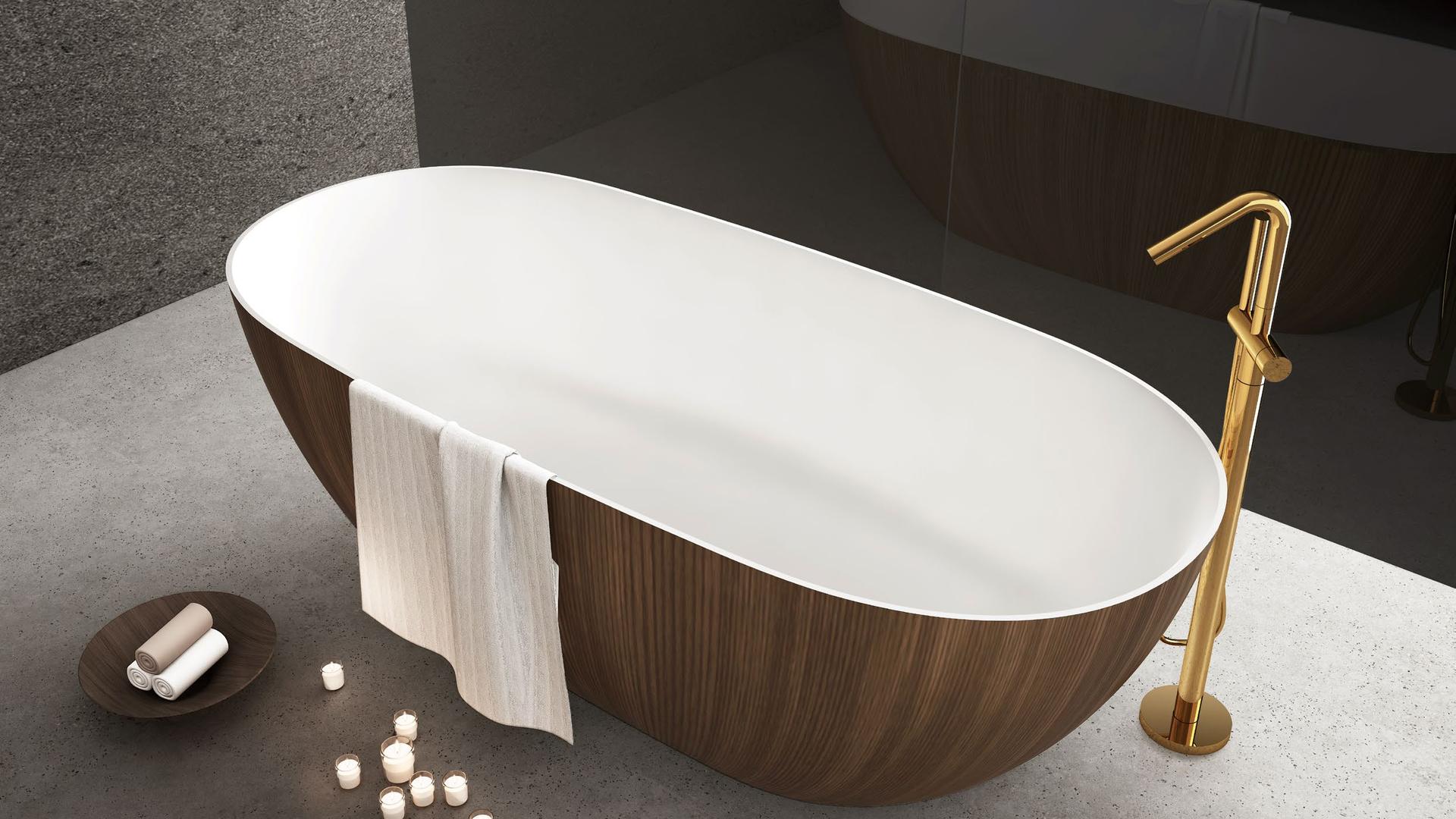 A cast solid surface bathtub with a floor-mounted faucet