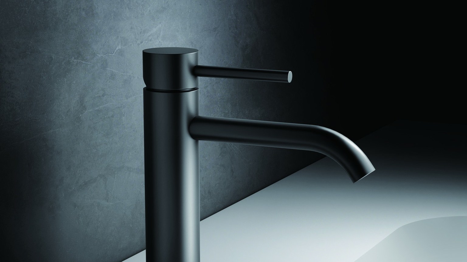A black single-hole basin faucet on a white basin