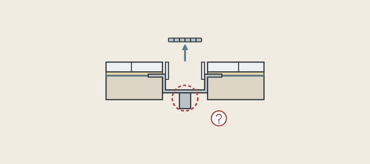 Illustration of a grate lifted out of a channel drain with a dashed circle and question mark around the outlet below