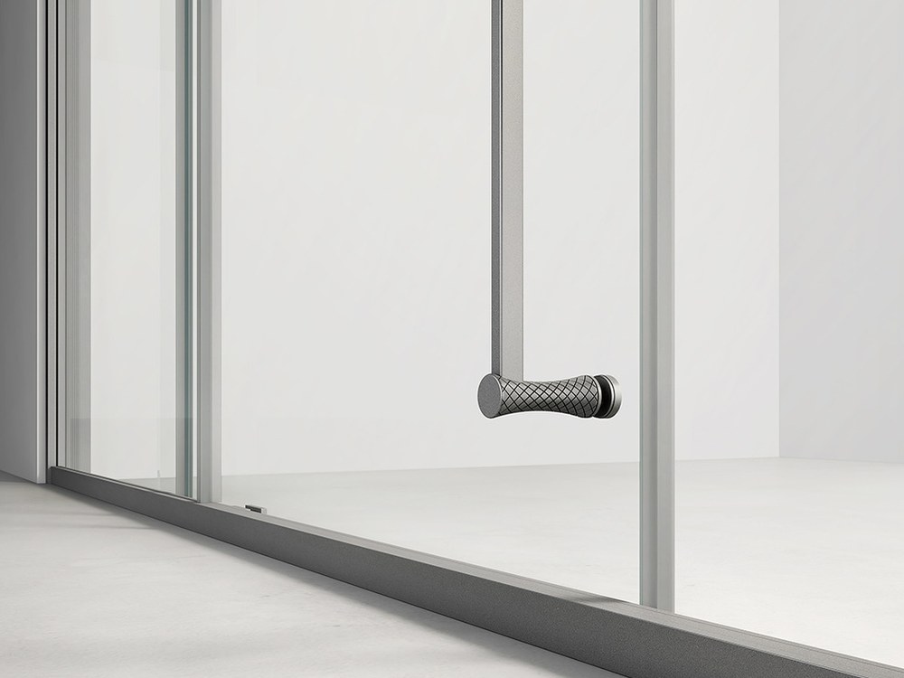 A drain channel running along the base of a glass shower screen
