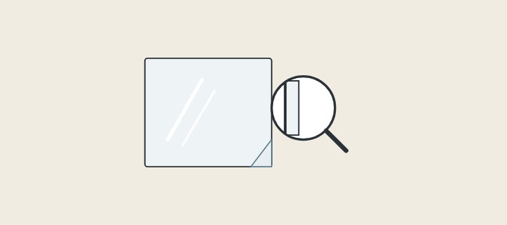 Illustration: a mirror with protective film at one corner and a magnifier over a mirror edge