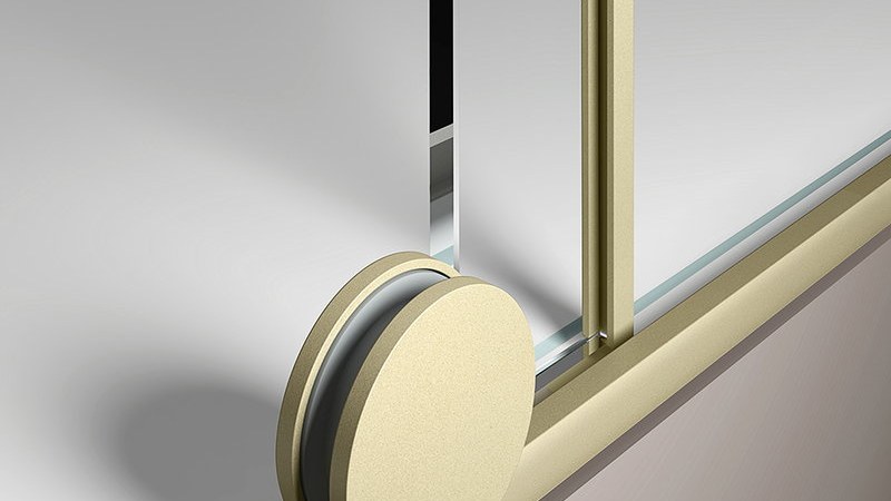 A close detail of a sliding shower door roller