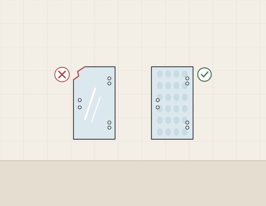 Illustration of a glass panel with a chipped corner marked with a cross beside a panel with a faint pattern marked with a tick