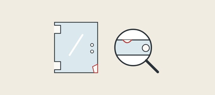 Illustration of a glass panel with a chipped corner beside a magnifier over a glass edge and hole