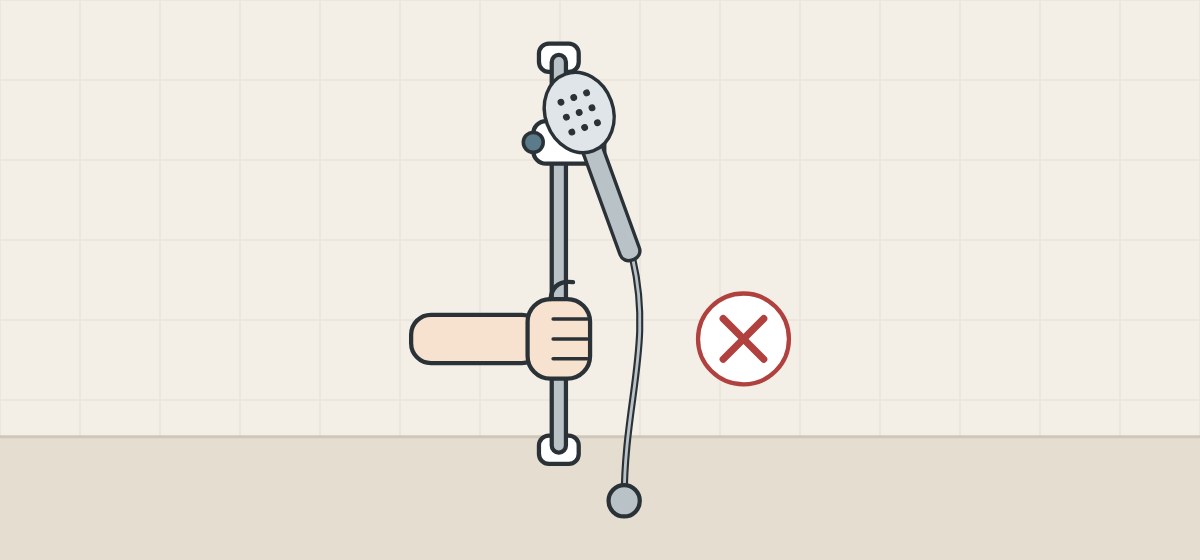 Illustration of a hand gripping a thin slide bar that holds a hand shower, with a cross beside it
