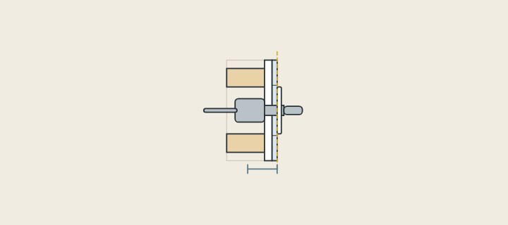 Illustration: a wall in section with a valve body behind the tile and a dashed line marking the finished wall face