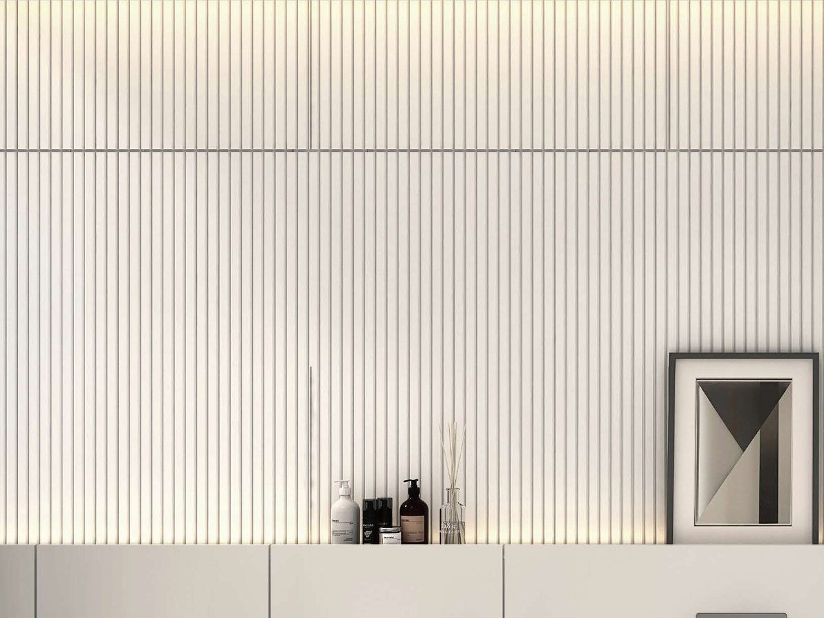 A fluted wall panel above a light-toned vanity counter