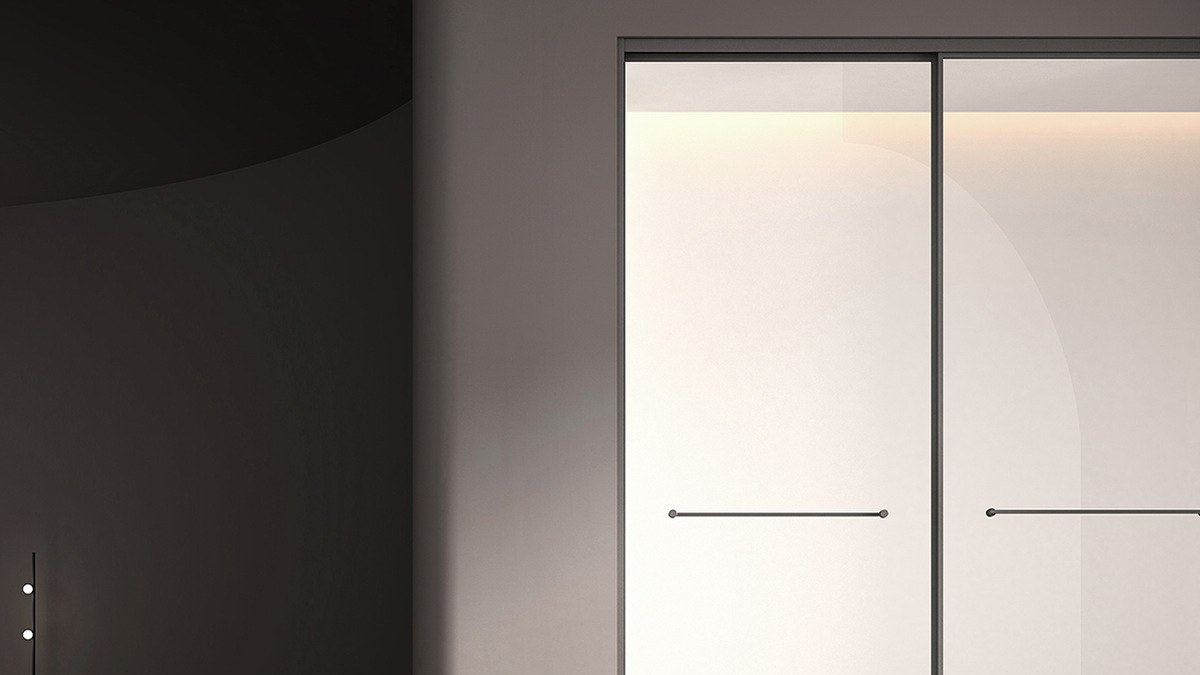 A sliding shower door shown on its track
