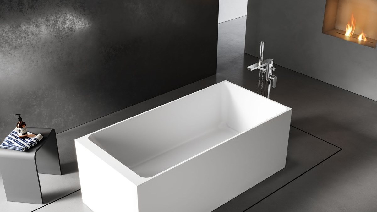A rectangular freestanding solid surface bathtub