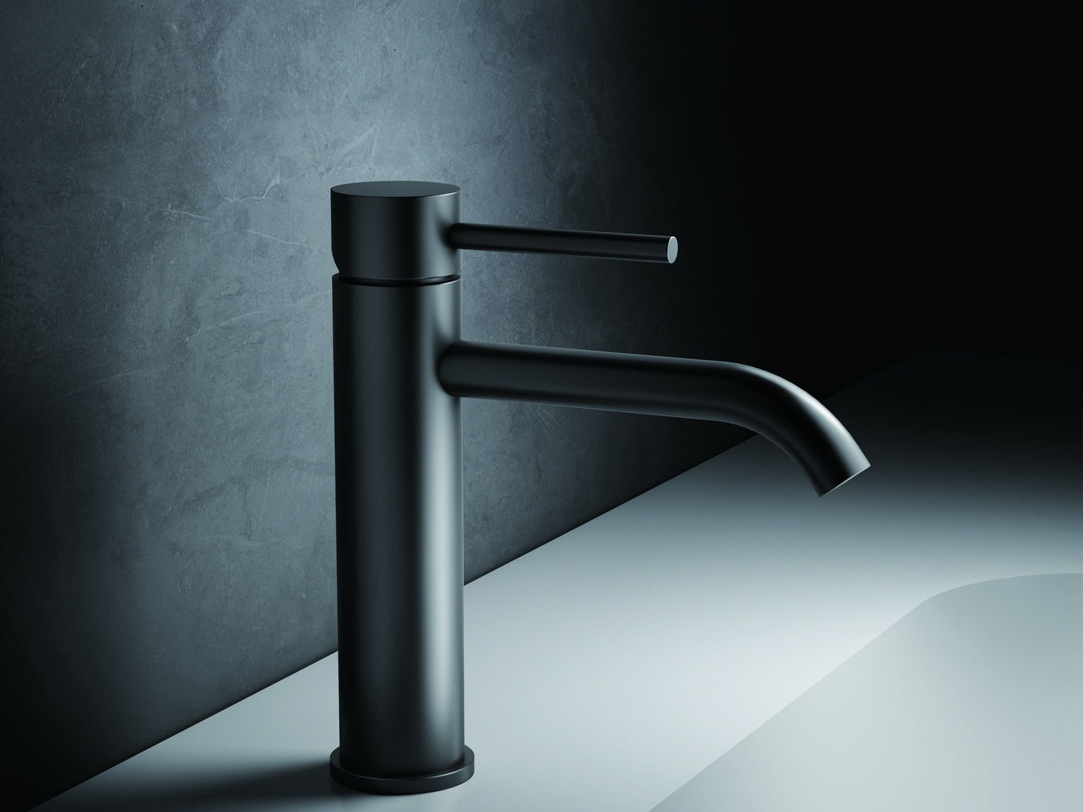 A black single-hole basin faucet on a white basin