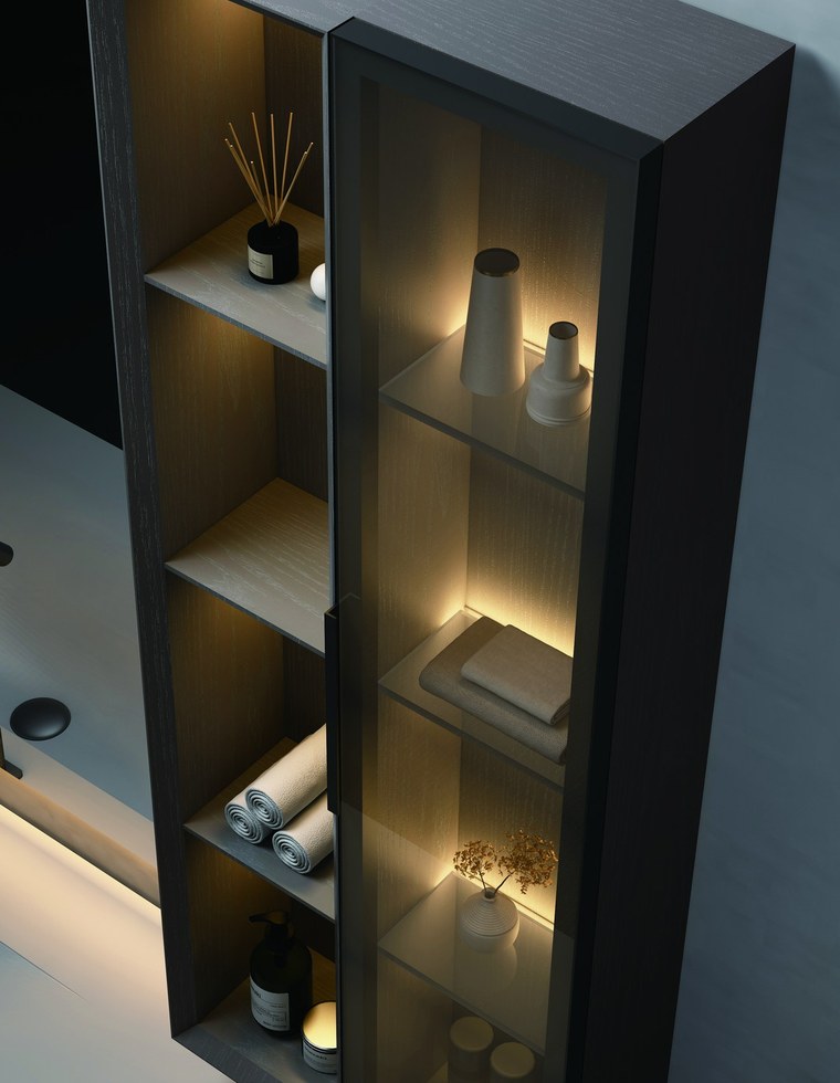 A dark vanity cabinet with open shelves and a wall-mounted tap