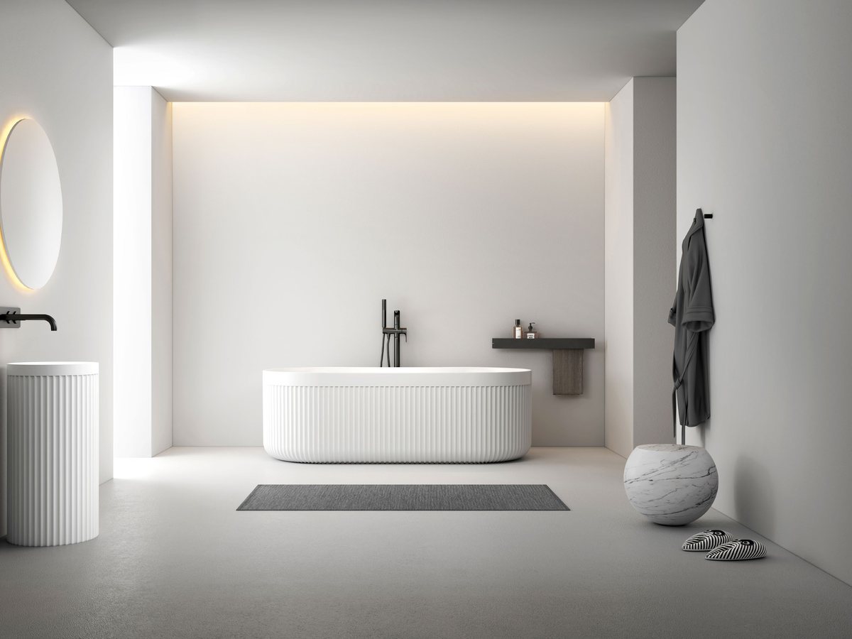 Solid surface freestanding bathtub displayed in a bright bathroom showroom