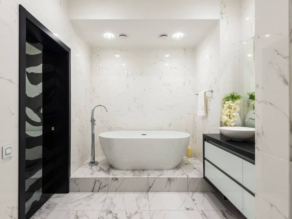 Hotel guest bathroom with a wall-hung vanity and freestanding bathtub