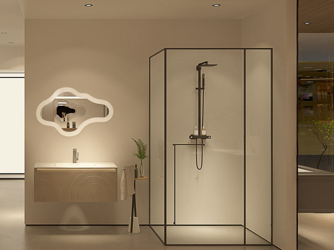Showroom vignette with a wall-hung vanity, sculpted mirror and black-framed shower enclosure