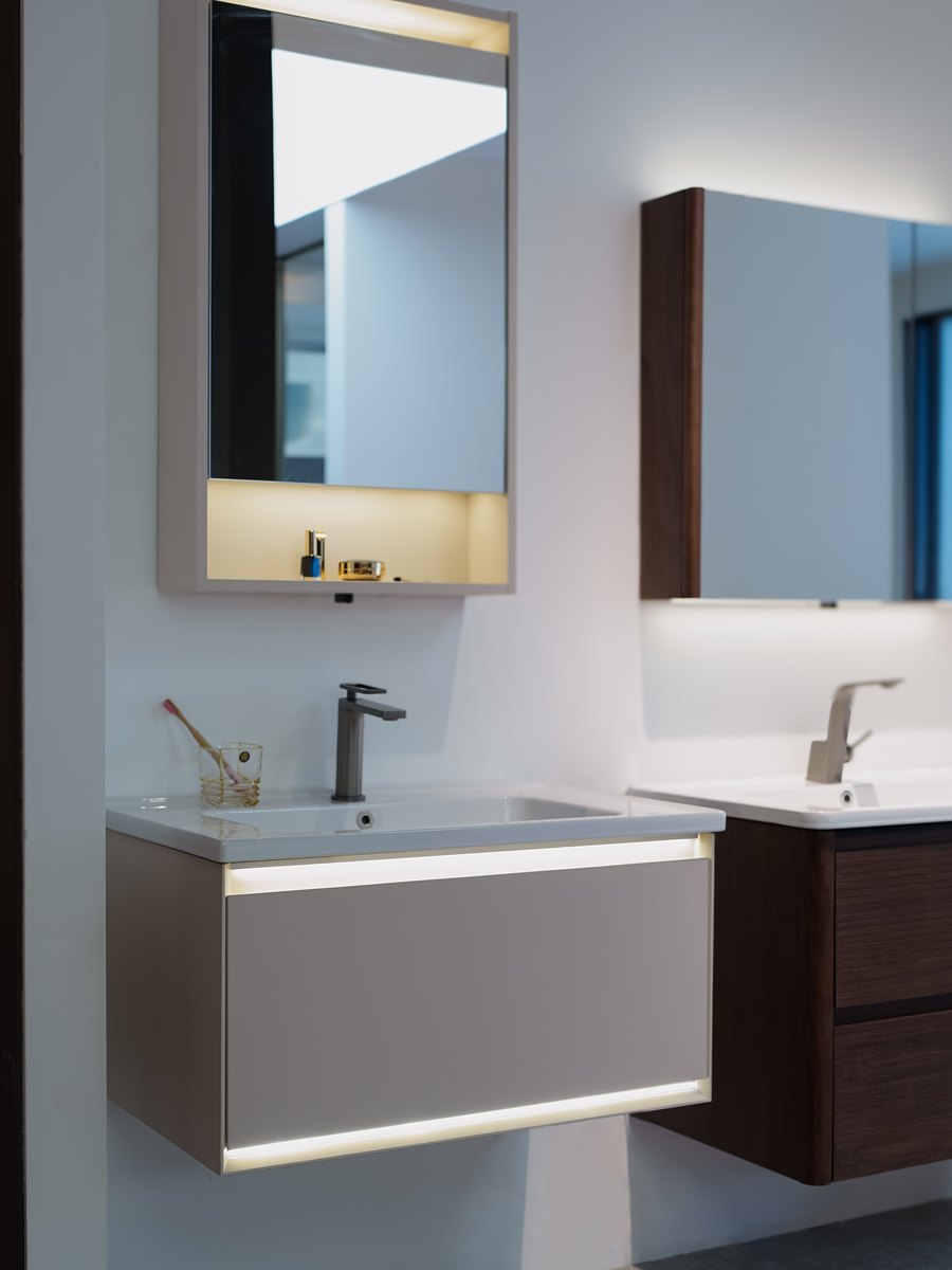 Wall-mounted WNS vanities with backlit mirror cabinets in the showroom