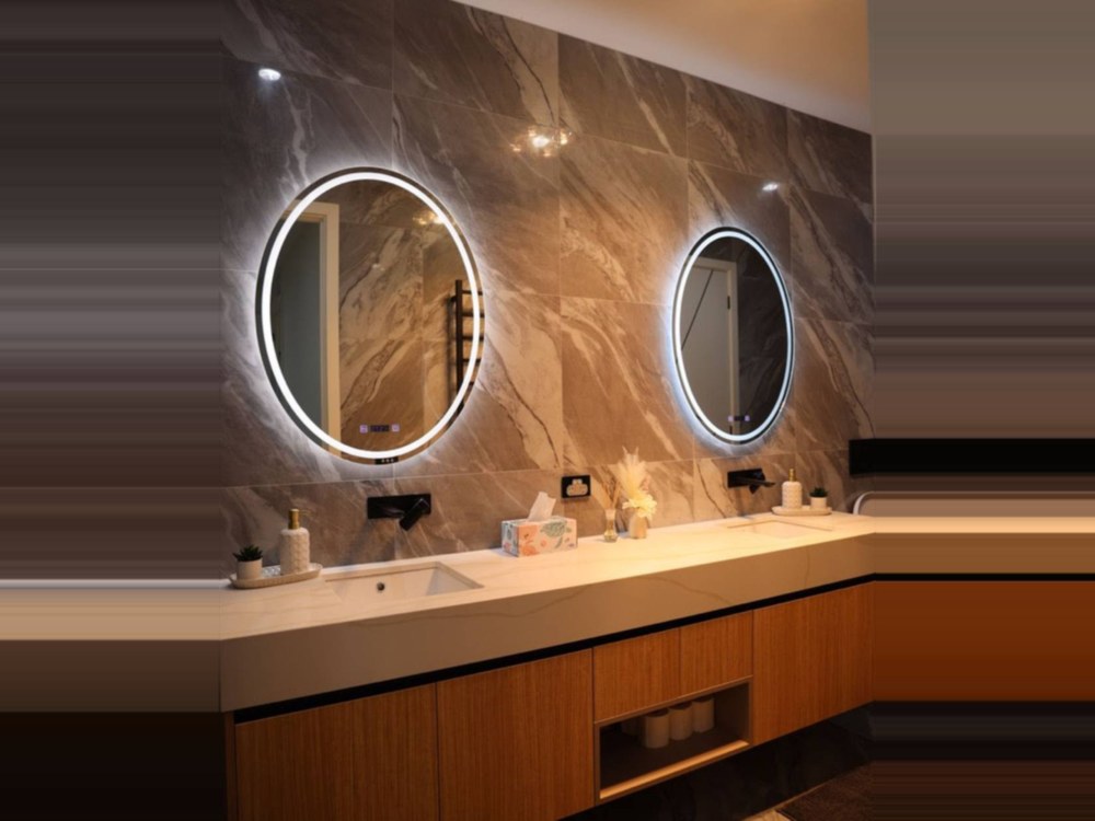 Wood-grain wall-hung vanity with stone top and twin backlit oval mirrors
