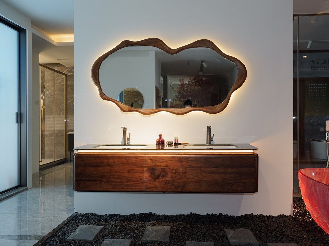 Walnut wall-mounted vanity suite with backlit organic mirror by WNS
