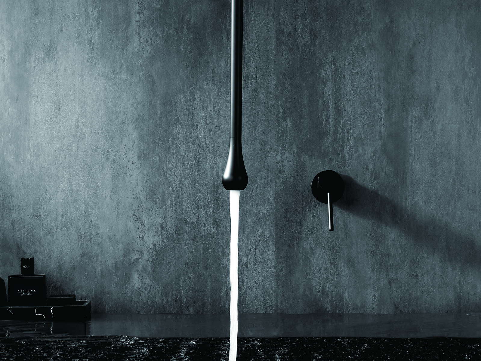Wall-mounted basin faucet above a vessel basin