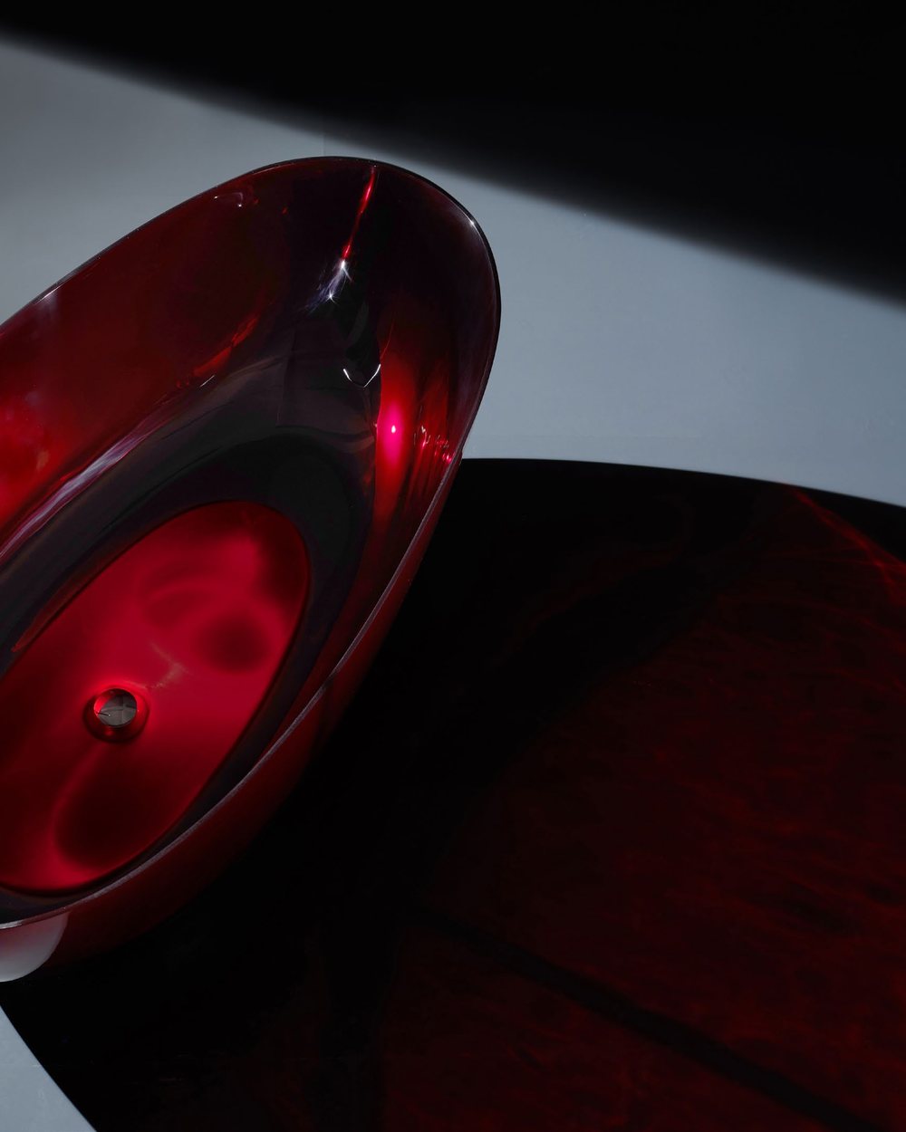 Ruby red translucent bathtub surface detail in low light