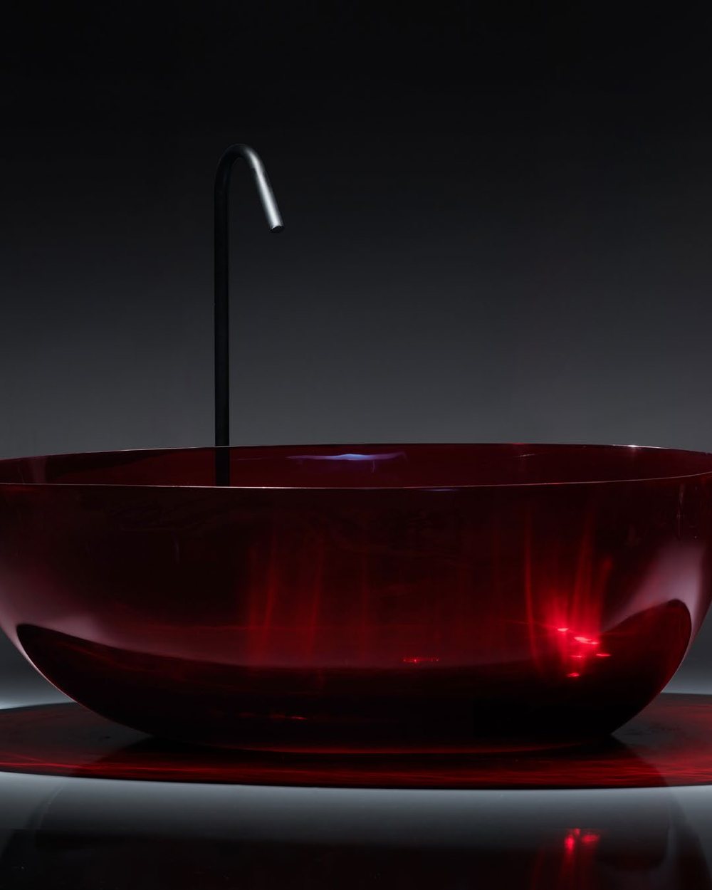 Ruby red translucent bathtub surface detail in low light